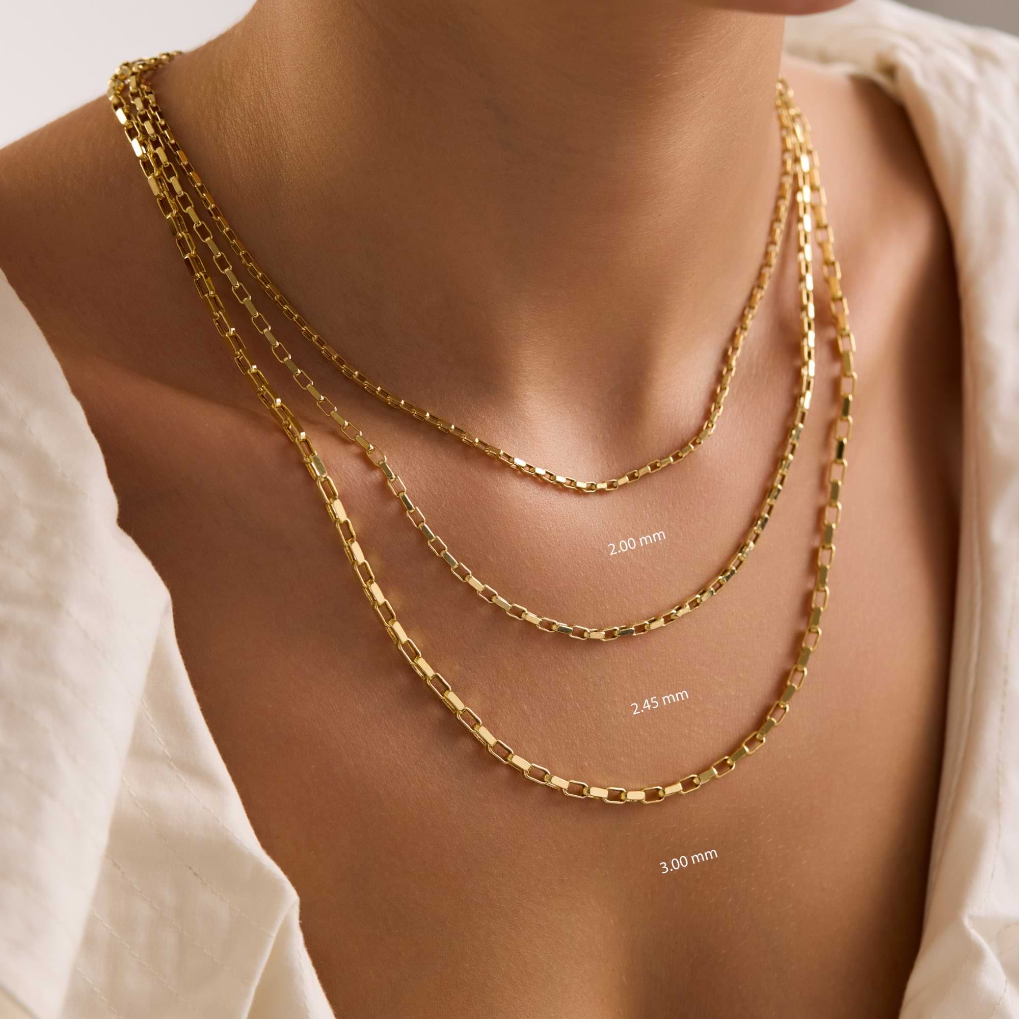 14k Gold cable chain necklaces of different thicknesses on a woman's neck