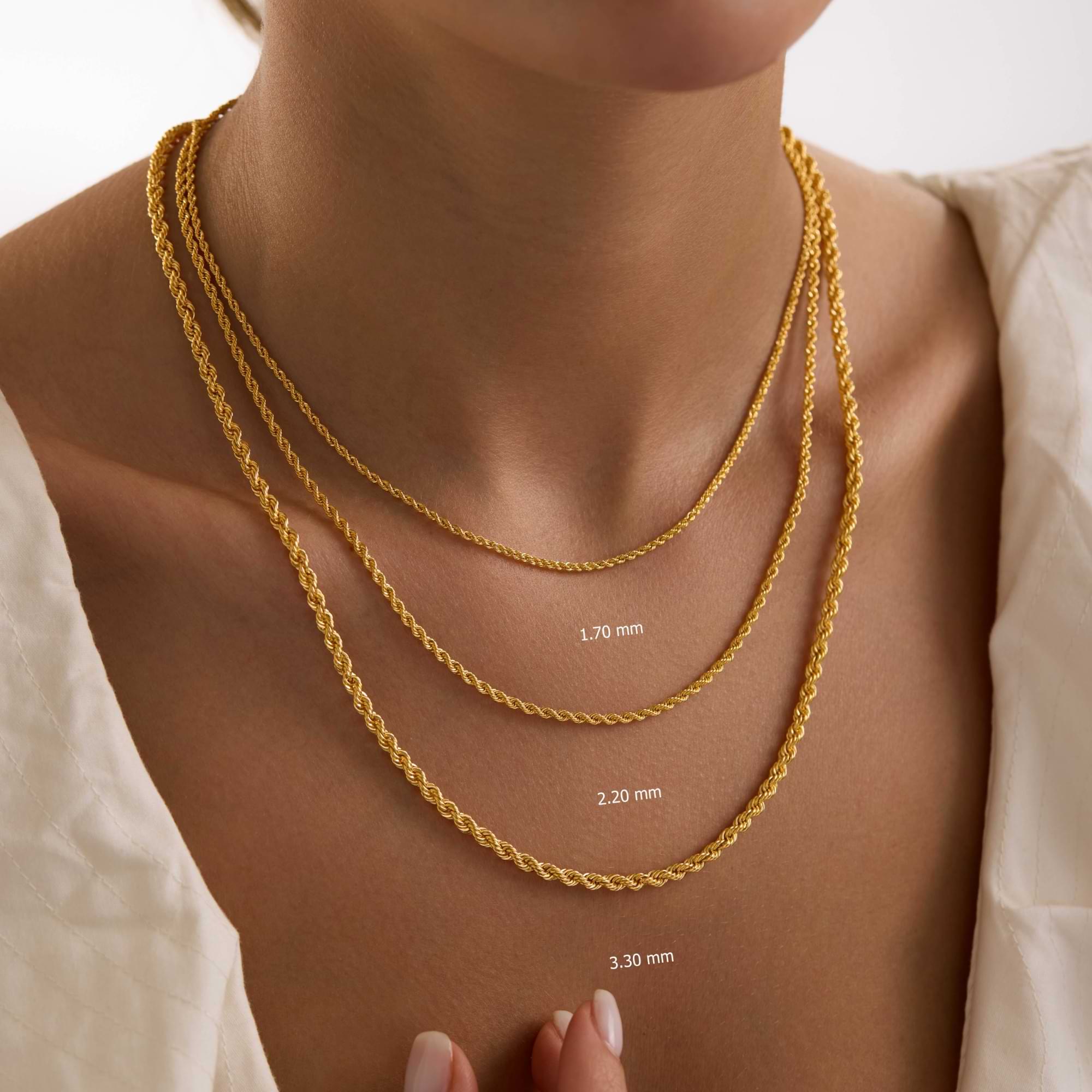 Gold rope chain necklaces on a woman's neck with different widths