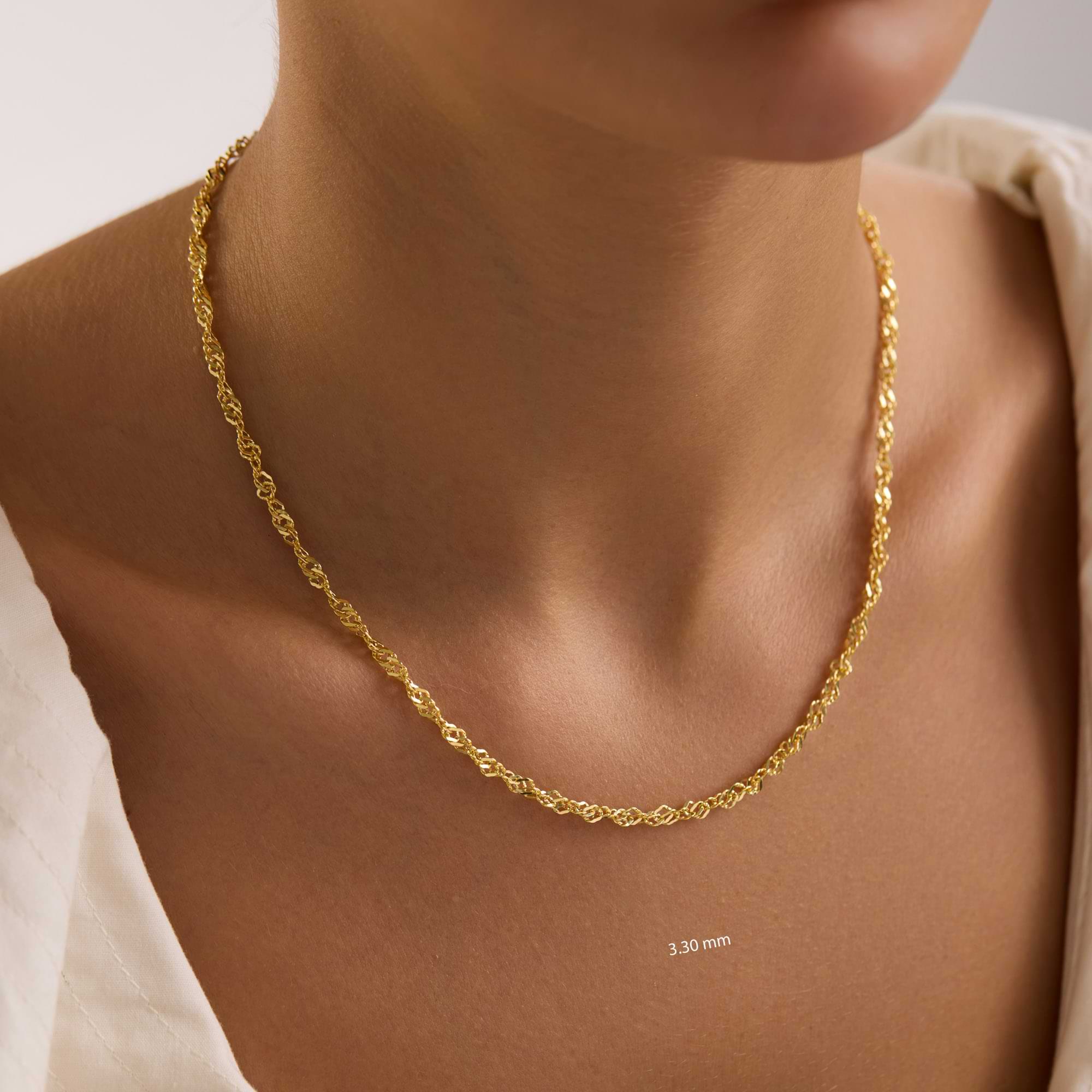 14k 3.3mm singapore necklace on a woman with a neutral background