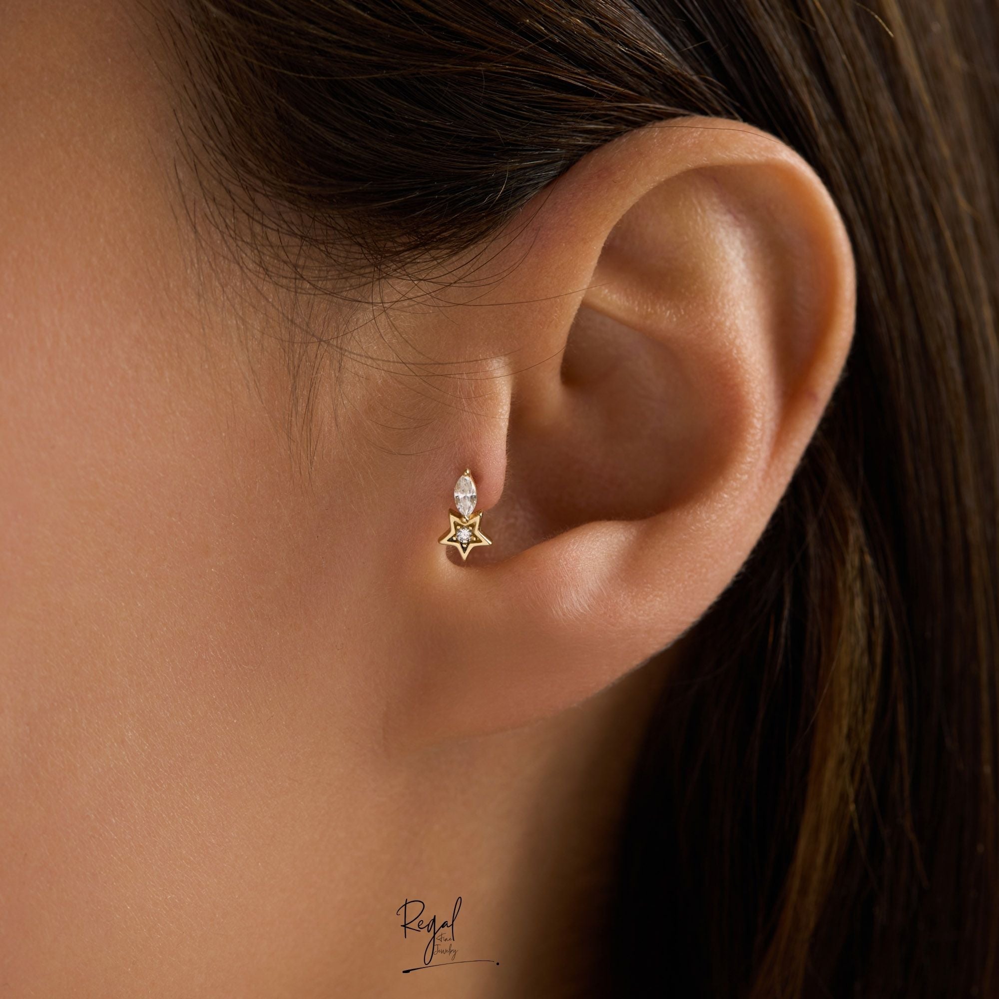 Close-up of an ear wearing a star-shaped piercing 