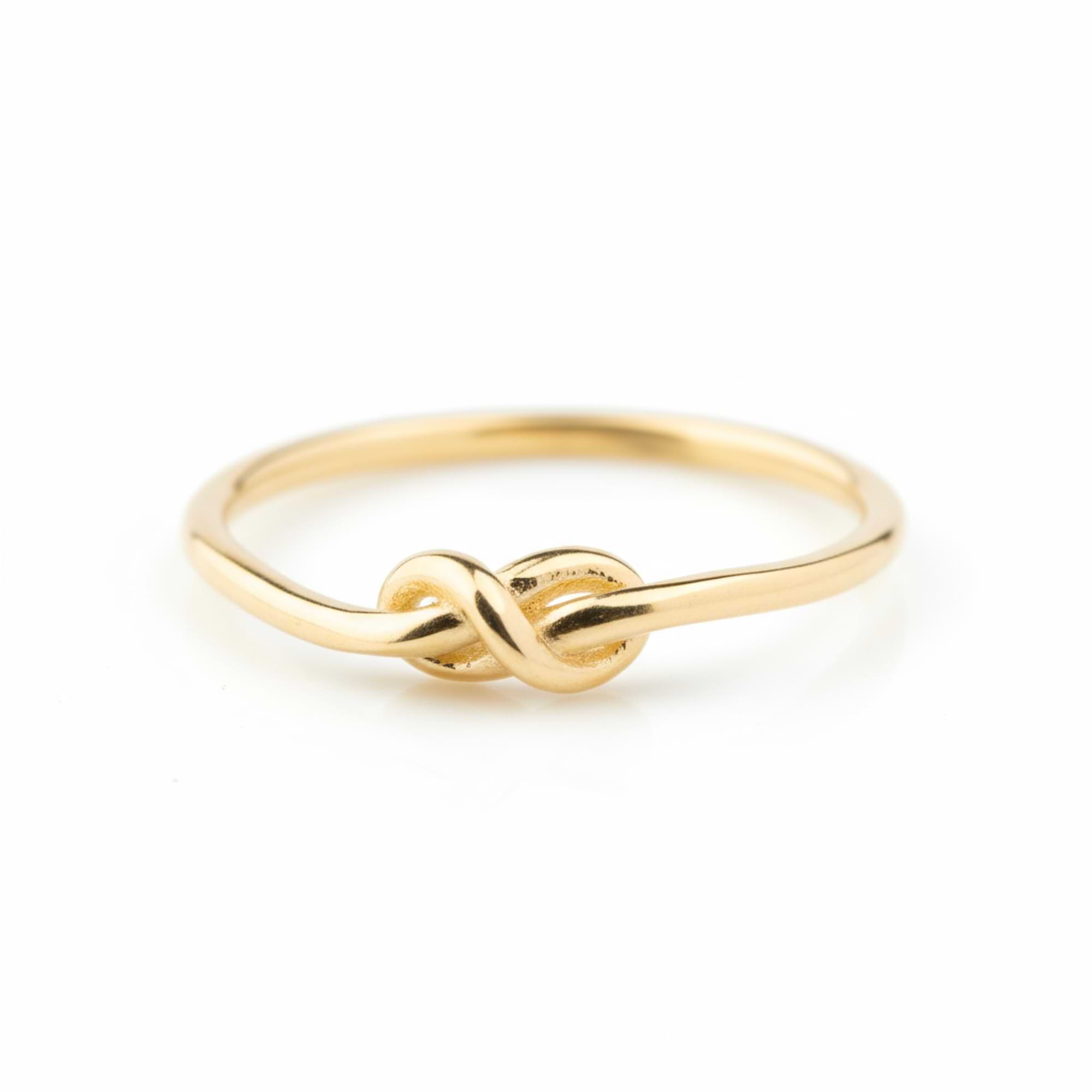14k Gold knot ring on a white background