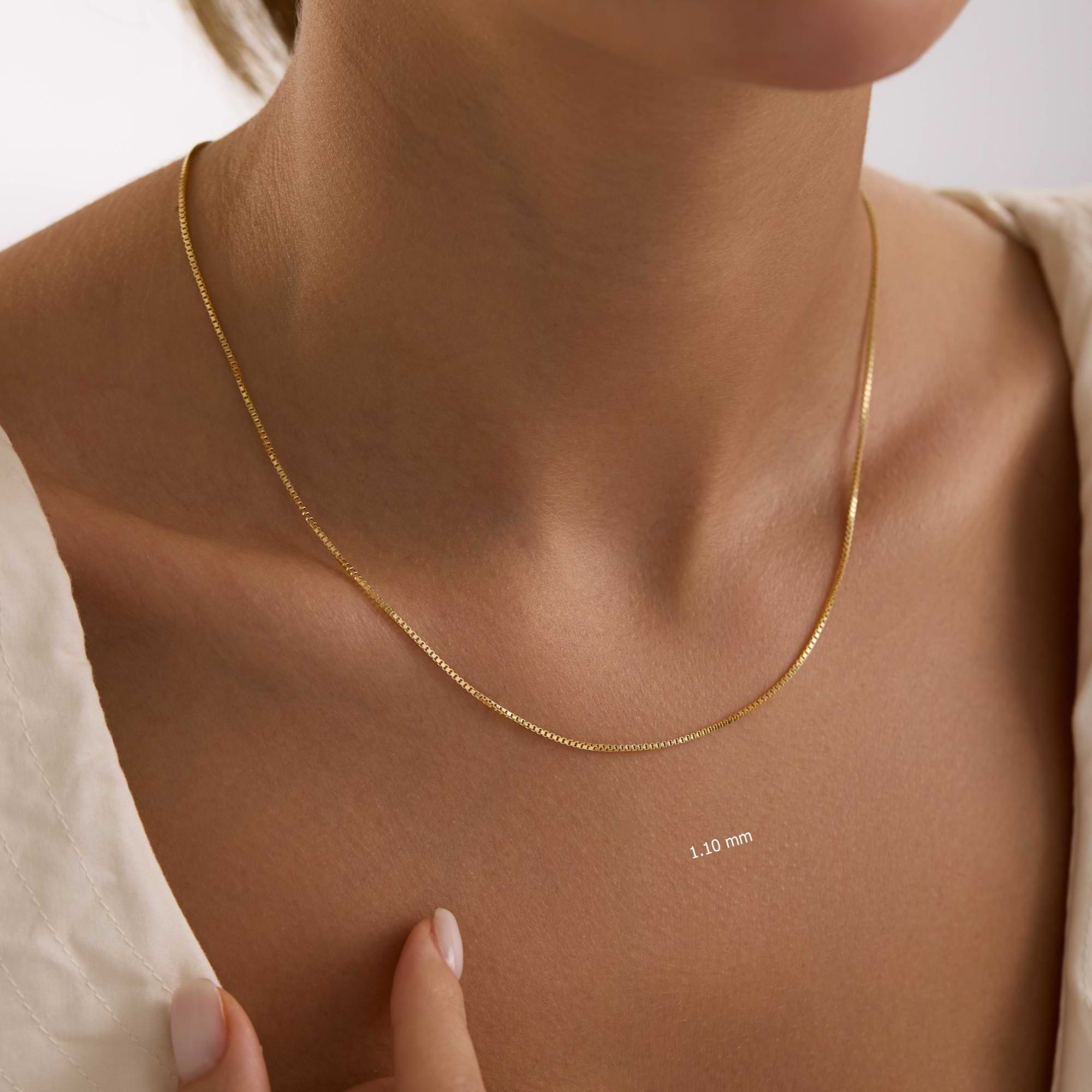 14k Gold 1.9mm box chain necklace on a woman's neck.