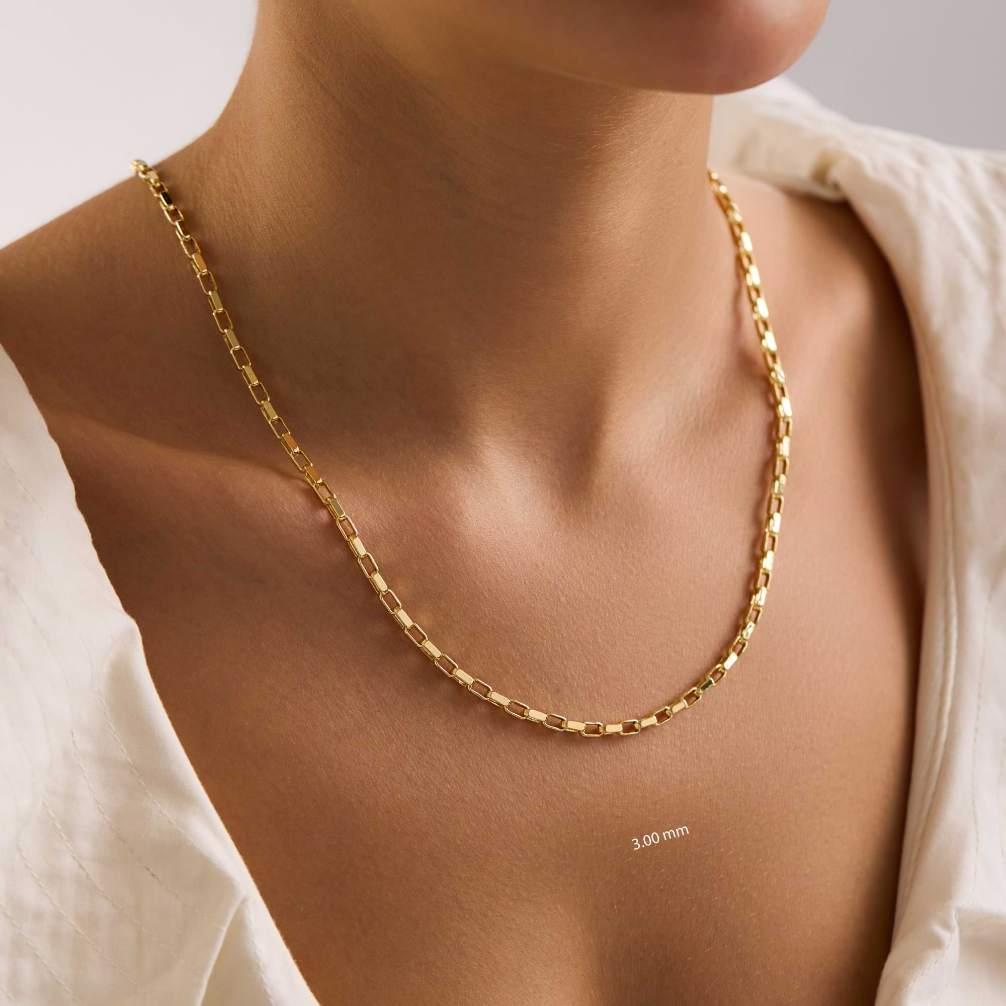14k Gold 3mm cable chain necklace on a lady with a neutral background