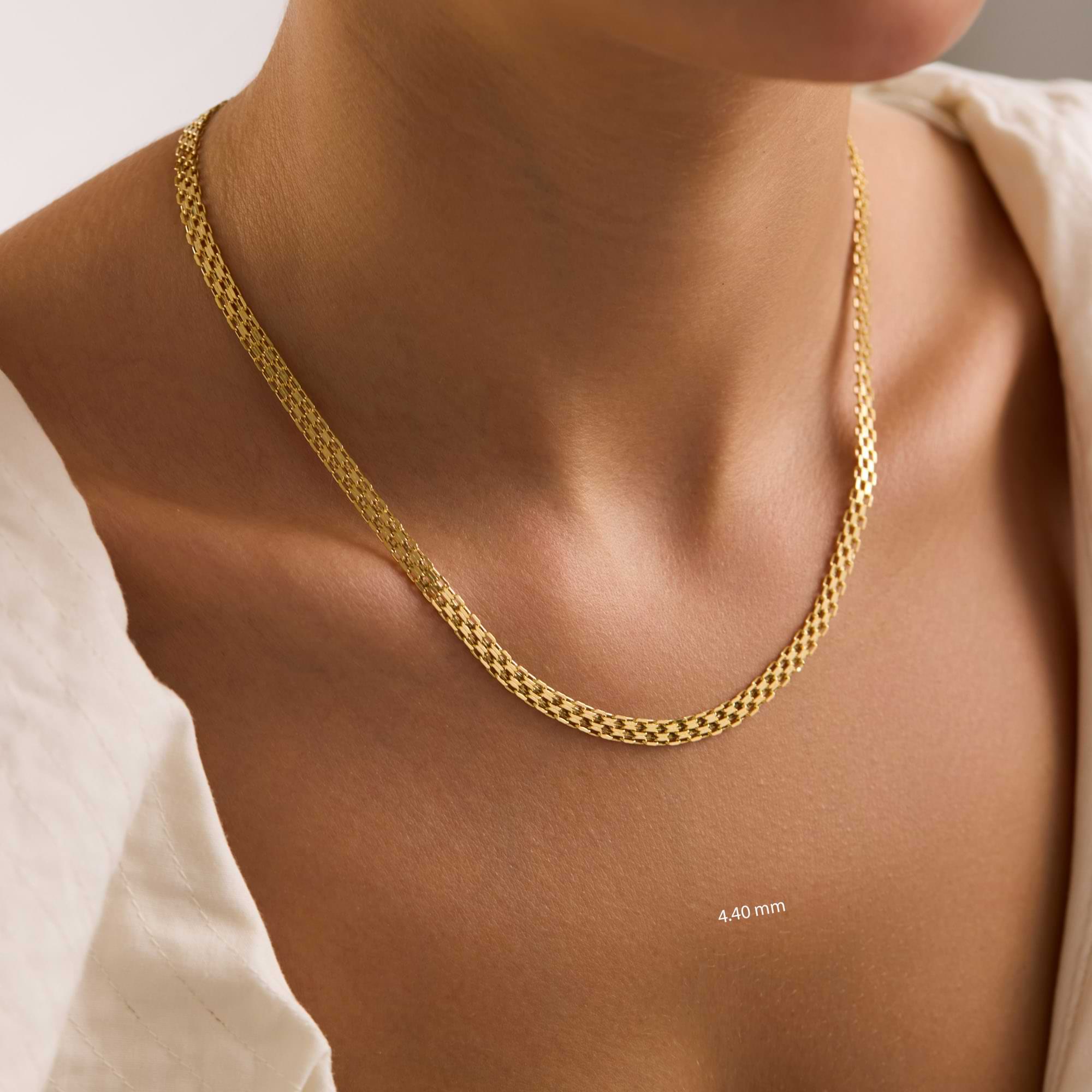 Gold 4.4mm bismark chain necklace on a person with a neutral background