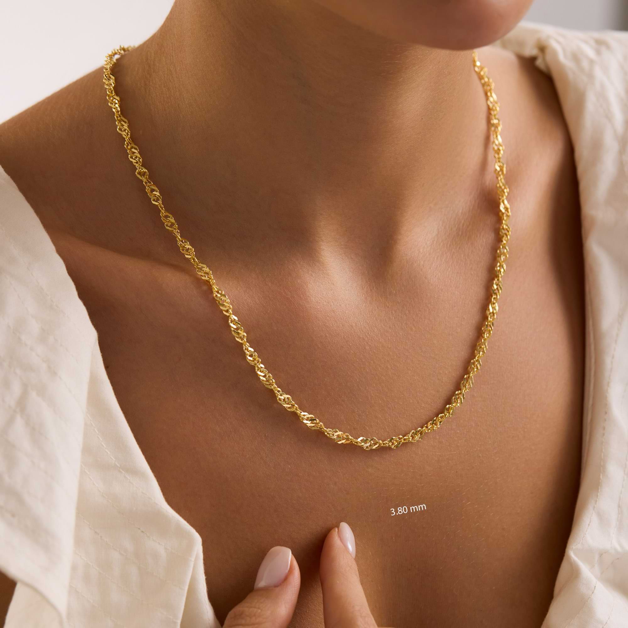 Thick 3.8mm 14k gold singapore chain on lady neck wearing white dress