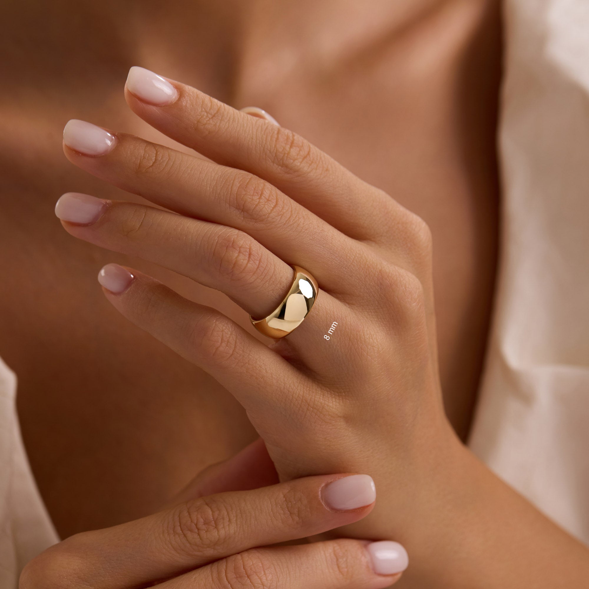 14k solid yellow gold 8mm wedding band on woman’s hand, extra-wide polished dome ring
