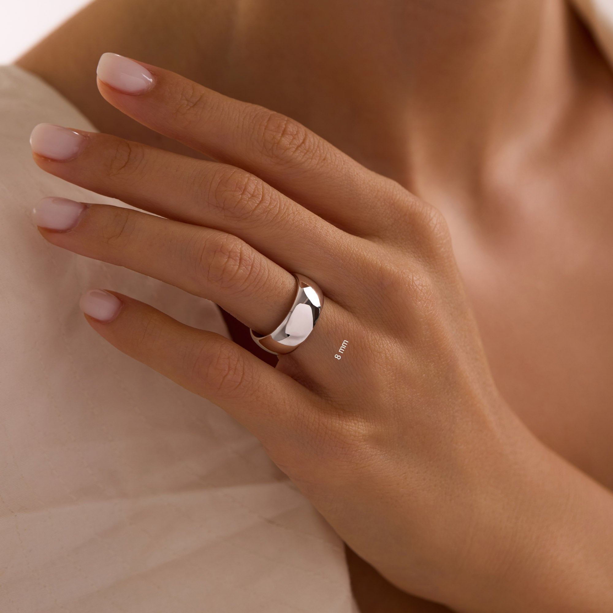 14k solid white gold 8mm wedding band on woman’s hand, extra-wide polished dome ring.”